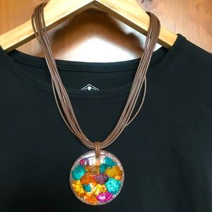 Multi-color medallion pendant with leather strands necklace.